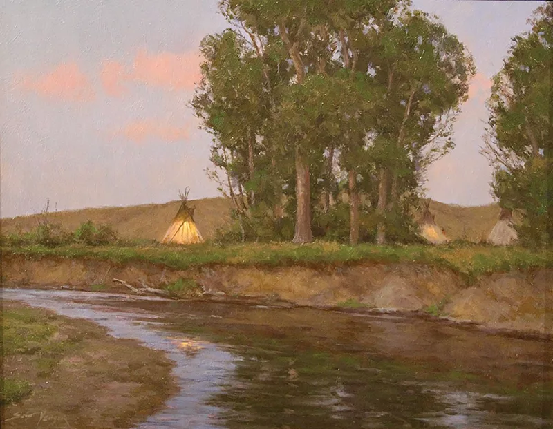 Two teepees near a gathering of trees on a riverbank