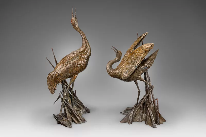 Bronze sculpture of two cranes.